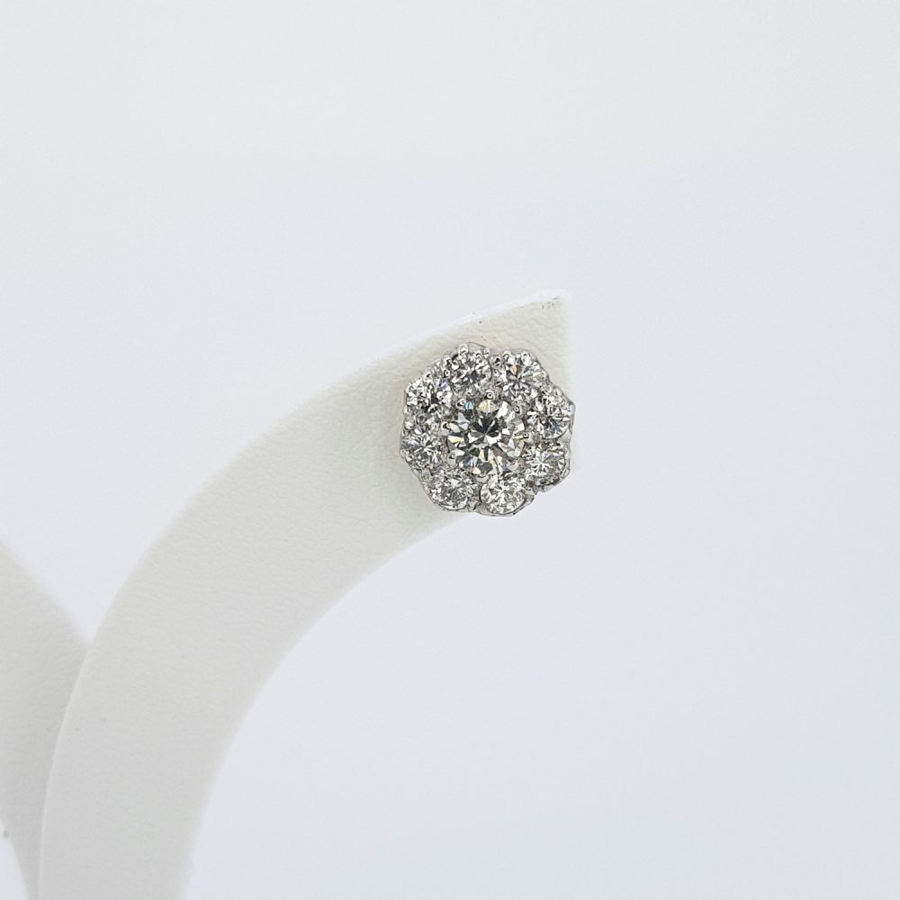 A single diamond cluster stud earring, on an earring display stand, against a white background