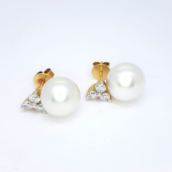 South Sea Pearl and Trefoil Diamond Stud Earrings; 12.5mm white South Sea pearls suspended from 1.20cts trefoil diamond studs, in 18ct yellow gold