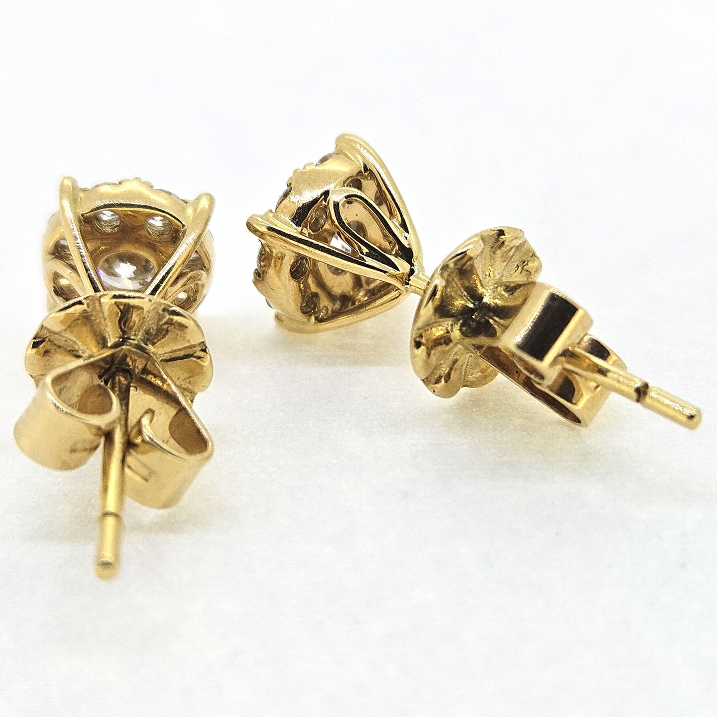 Diamond cluster studs earrings in 18ct yellow gold, on a white background