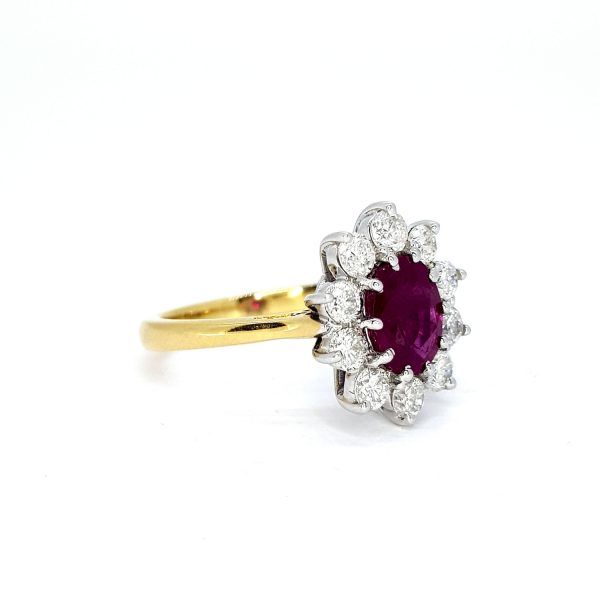 Ruby and Diamond Cluster Ring; central oval faceted ruby surrounded by ten brilliant-cut diamonds, claw set in 18ct white gold, mounted to plain 18ct yellow gold shank