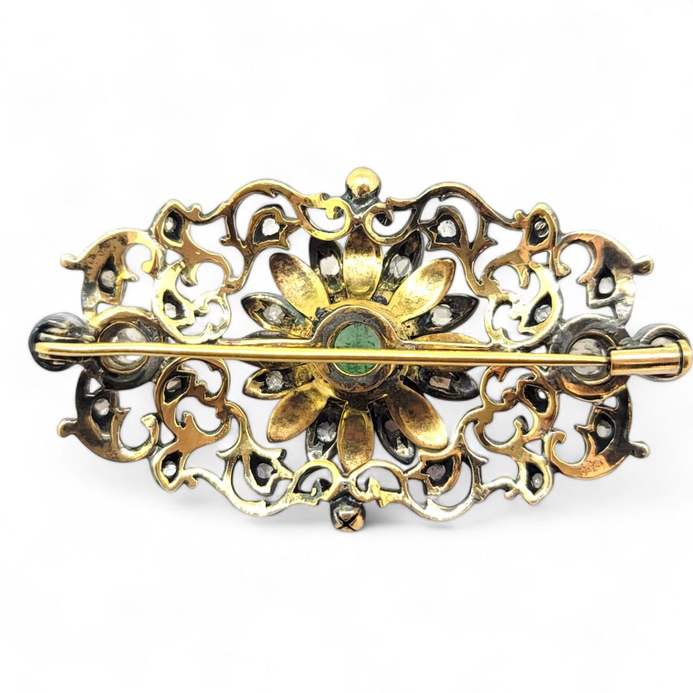 Victorian Antique Emerald Rose Diamond and Enamel Brooch, emerald-cut emerald surrounded by enamel decorated flower petals central to rose-cut diamond silver set pierced surround