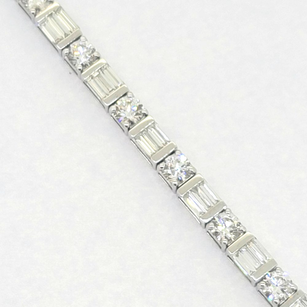 Baguette and Brilliant Cut Diamond Line Tennis Bracelet, set with 6.40 carats of round brilliant-cut and baguette-cut diamonds in 18ct white gold. 17cm