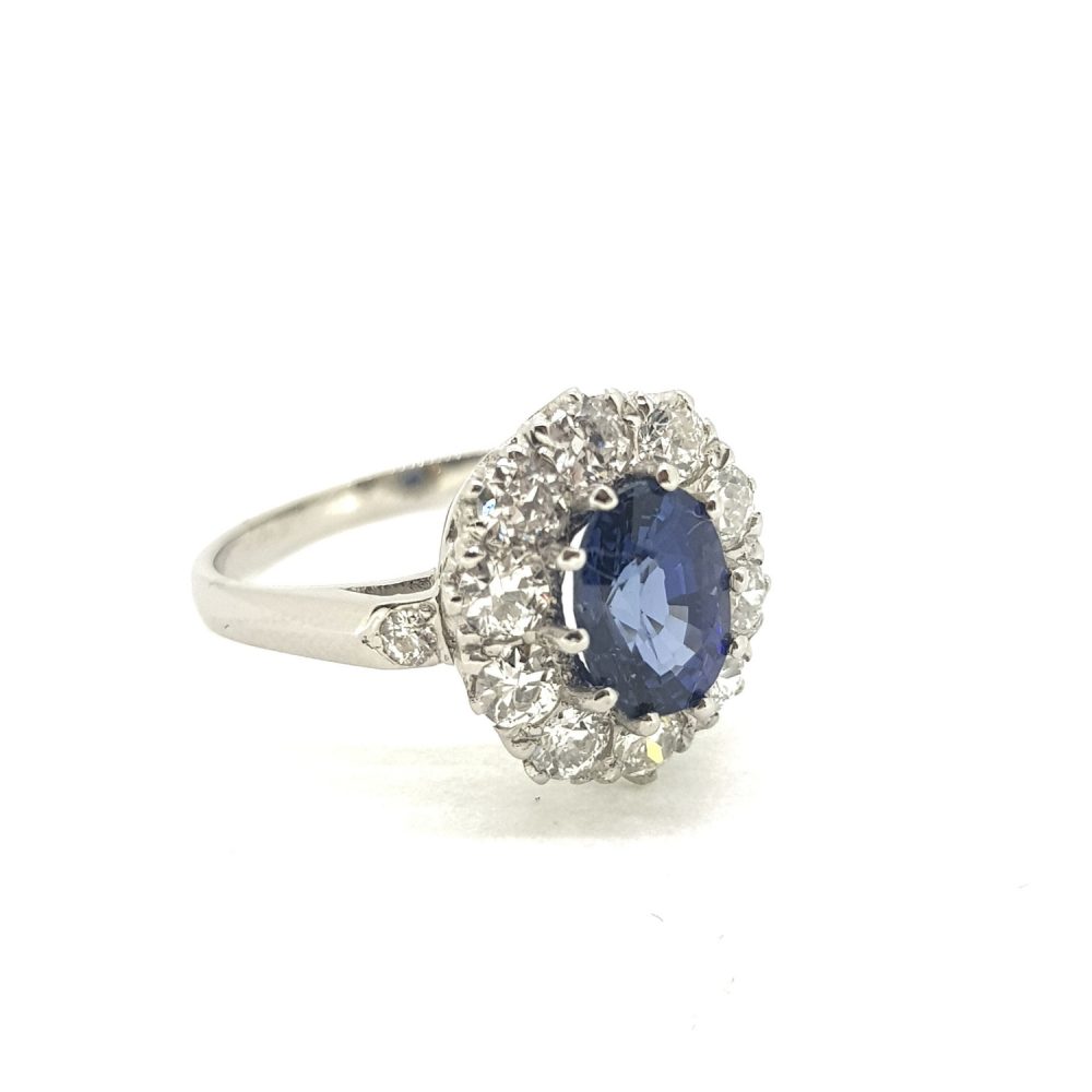 1.50ct Oval Cut Sapphire and Diamond Cluster Ring; central oval blue sapphire surrounded by 0.90cts diamonds, in 18ct white gold