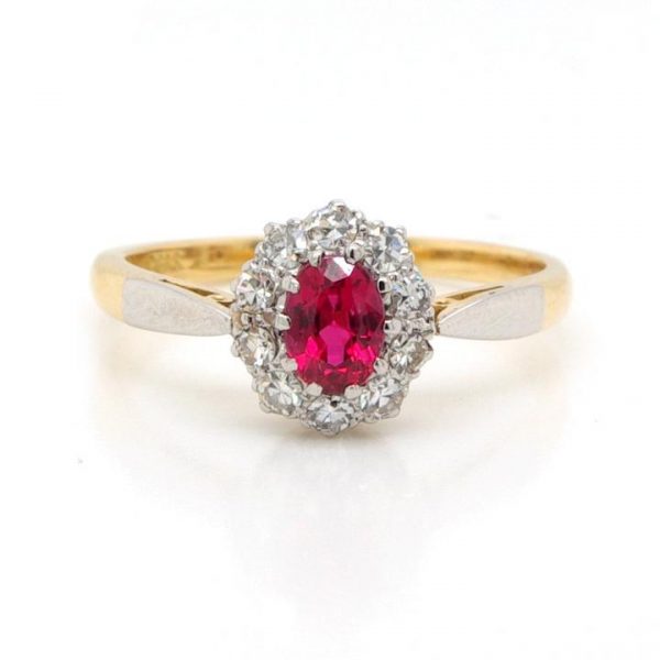 Vintage Red Spinel and Diamond Cluster Ring; oval faceted spinel surrounded by 0.36cts single cut diamonds, in 18ct yellow gold. Circa 1930s
