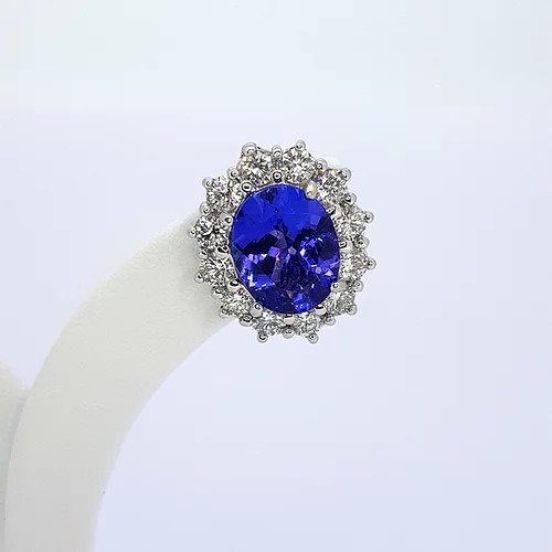 Tanzanite and Diamond Oval Cluster Earrings; 5.20cts oval faceted tanzanites surrounded by 1.76cts round brilliant-cut diamonds, in 18ct white gold