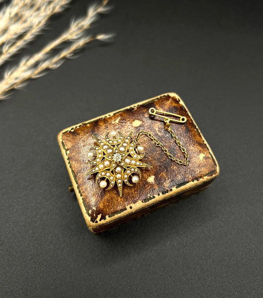 An antique diamond and pearl star and crescent brooch/pendant in yellow gold
