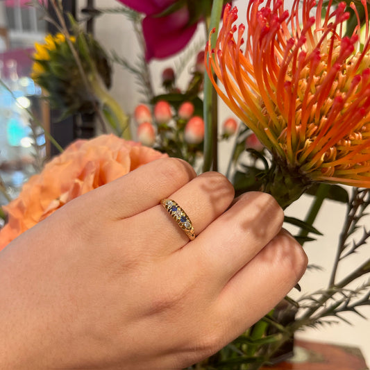 A sapphire and diamond five stone ring in yellow gold, modelled on a hand