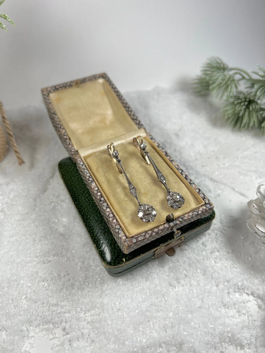 A pair of long drop earrings with diamonds, in an antique box