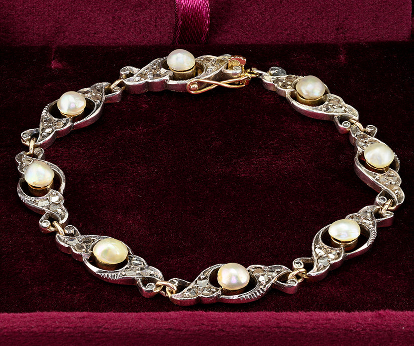 Edwardian Antique Natural Pearl and Rose Cut Diamond Bracelet, openwork scroll links set with rose-cut diamonds around natural pearls in silver upon 18ct yellow gold. Circa 1905