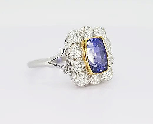 2.16ct Natural Sapphire and Diamond Cluster Ring; 2.16 carat cushion-shaped natural sapphire, surrounded by 0.98cts diamonds, in 18ct white and yellow gold