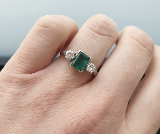 Emerald three stone engagement ring