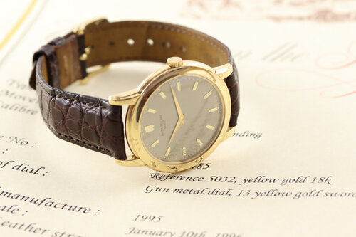 Patek Philippe 5032 Calatrava 36mm Automatic Watch in 18ct Yellow Gold, gun metal dial, 13 yellow gold sword-shaped indexes, sapphire crystal, calibre 240, in mint condition, with Patek Philippe pouch and extract, 1995