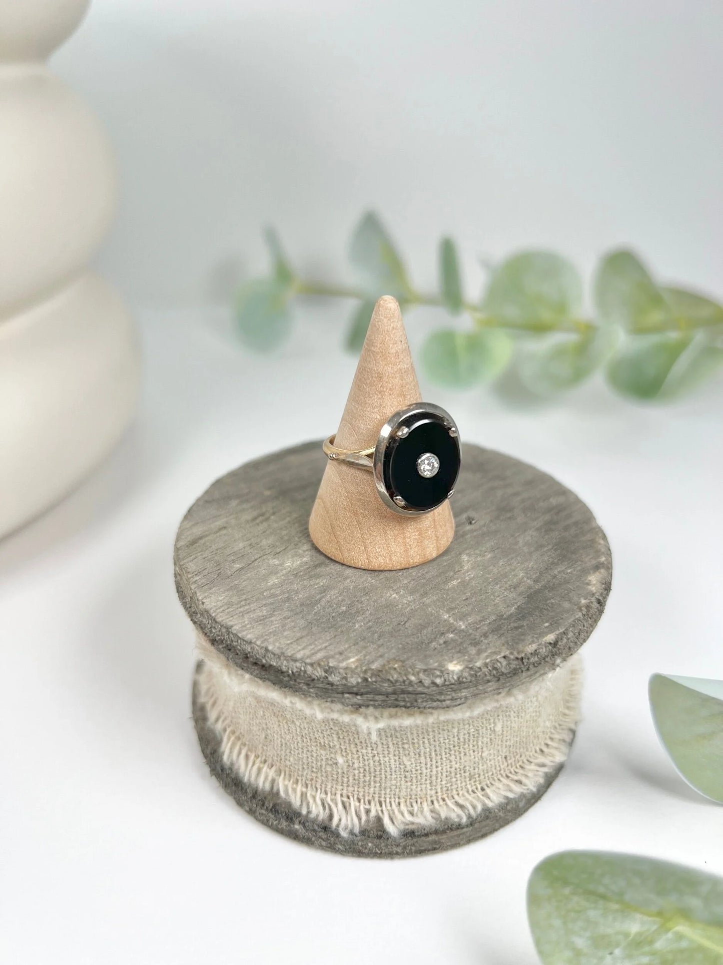 Art Deco 18 Carat Two Colour Gold Oval Onyx and Diamond Halo Ring, Circa 1920