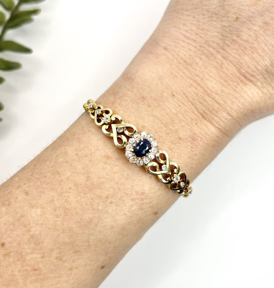 Edwardian Antique Sapphire and Diamond Cluster Fancy Heart Link Gold Curb Bracelet, 18ct yellow gold curb link bracelet with central oval sapphire and diamond cluster flanked by diamond-set heart-shaped links, Circa 1900