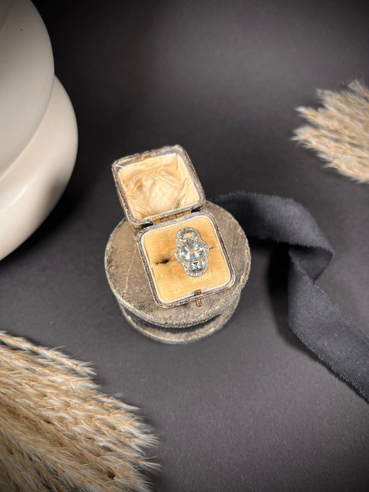 An aquamarine and diamond cocktail cluster ring, in an antique ring box