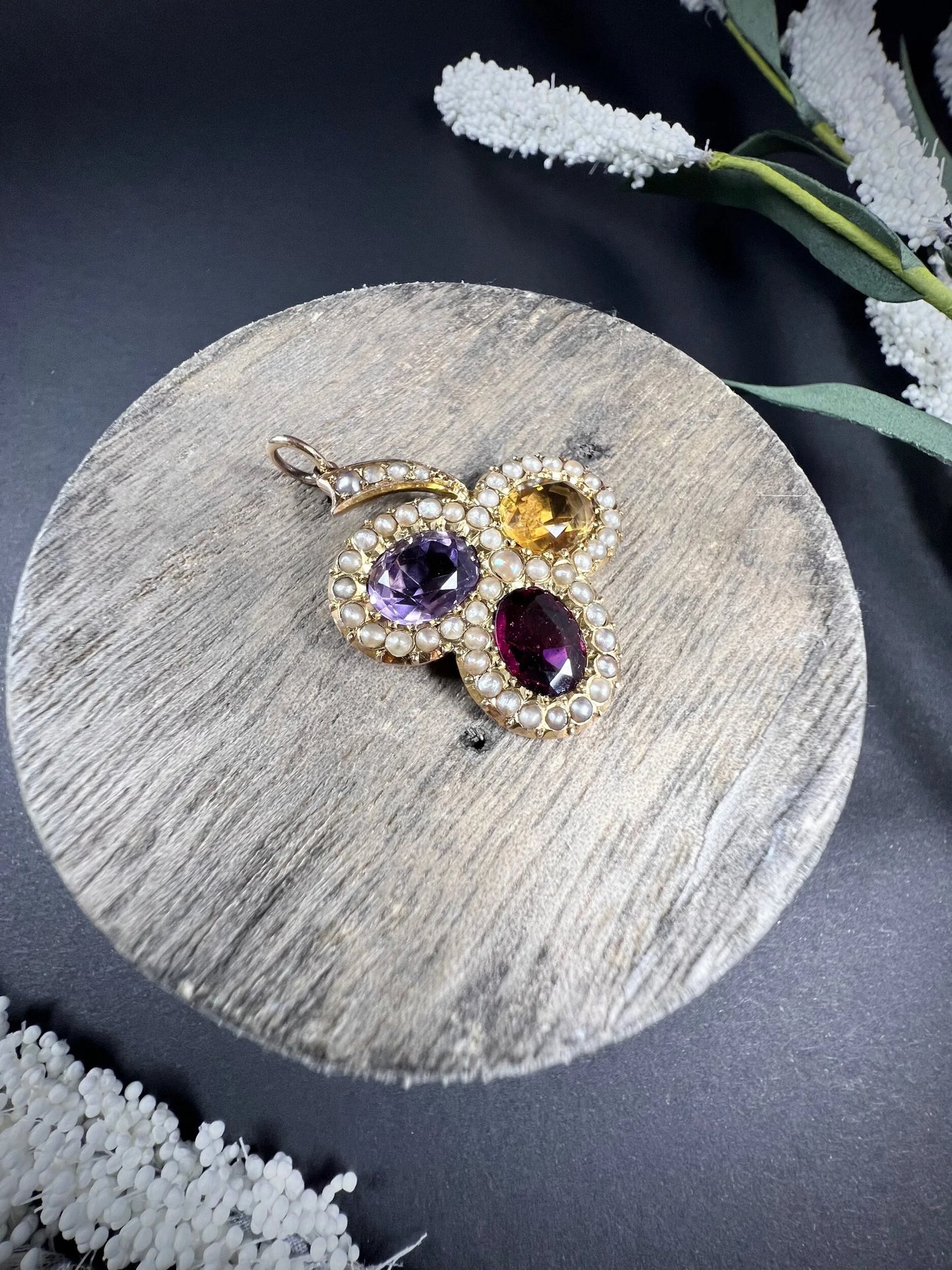 A yellow gold clover pendant with amethyst, citrine, garnet and seed pearls