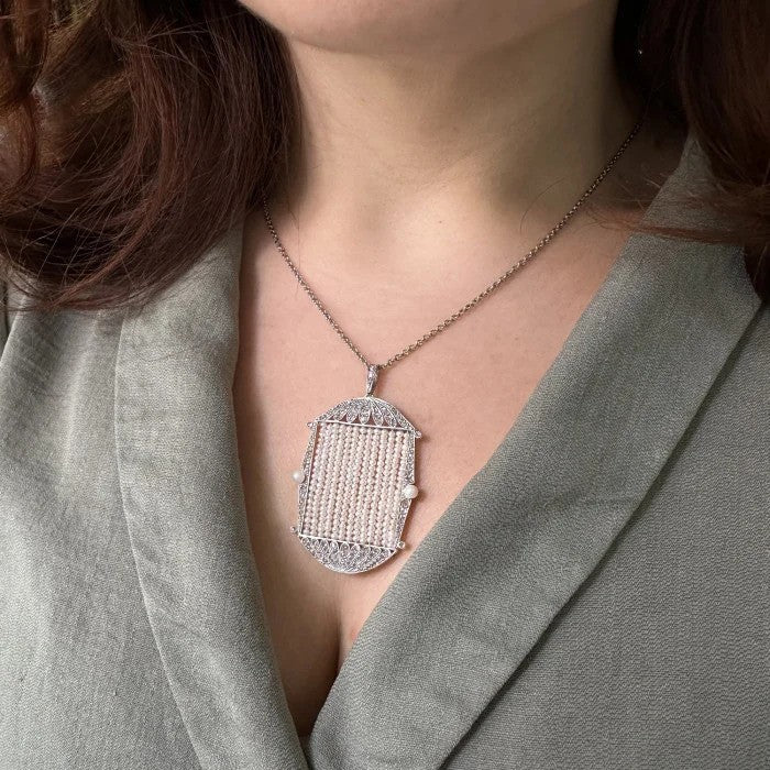 Art Deco Natural Pearl and Diamond Pendant in Platinum, central panel with seed pearl rows in rose cut diamond set frame with natural pearl to each side