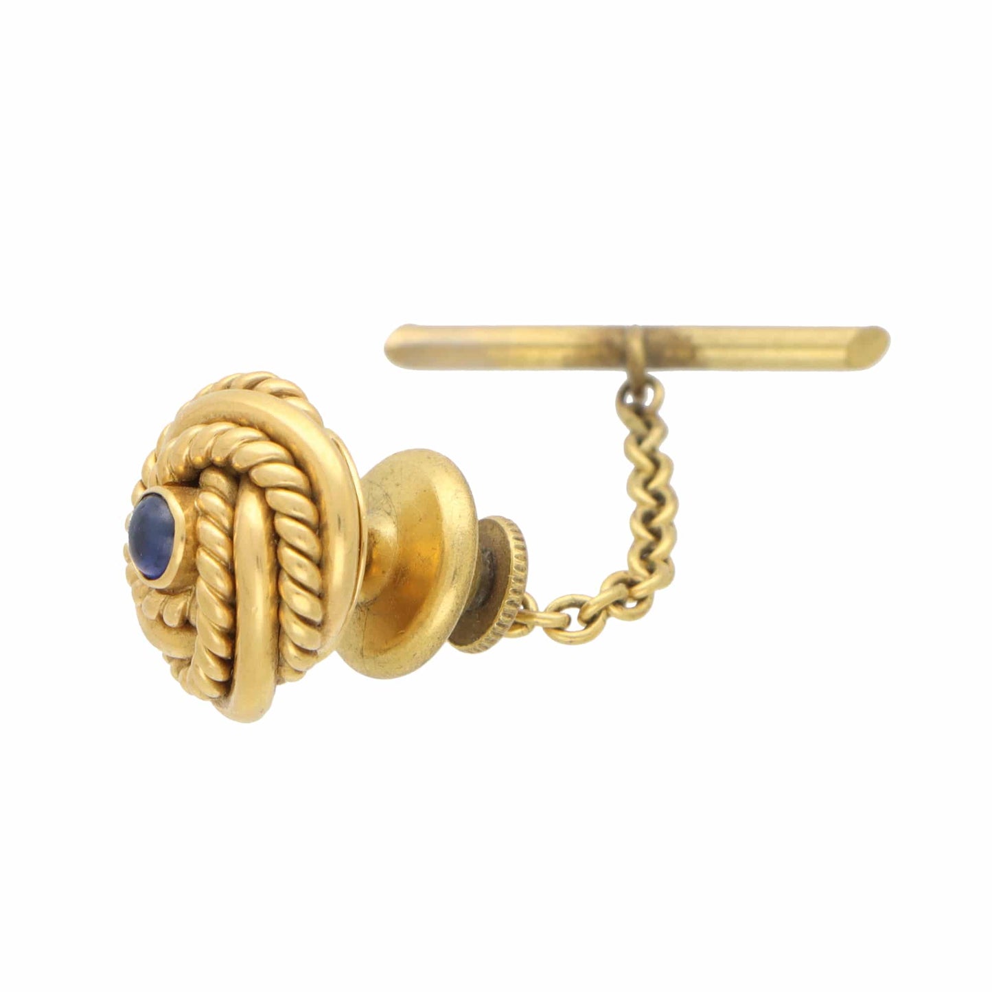 A yellow gold knot design tie tack with a blue sapphire, on a white background