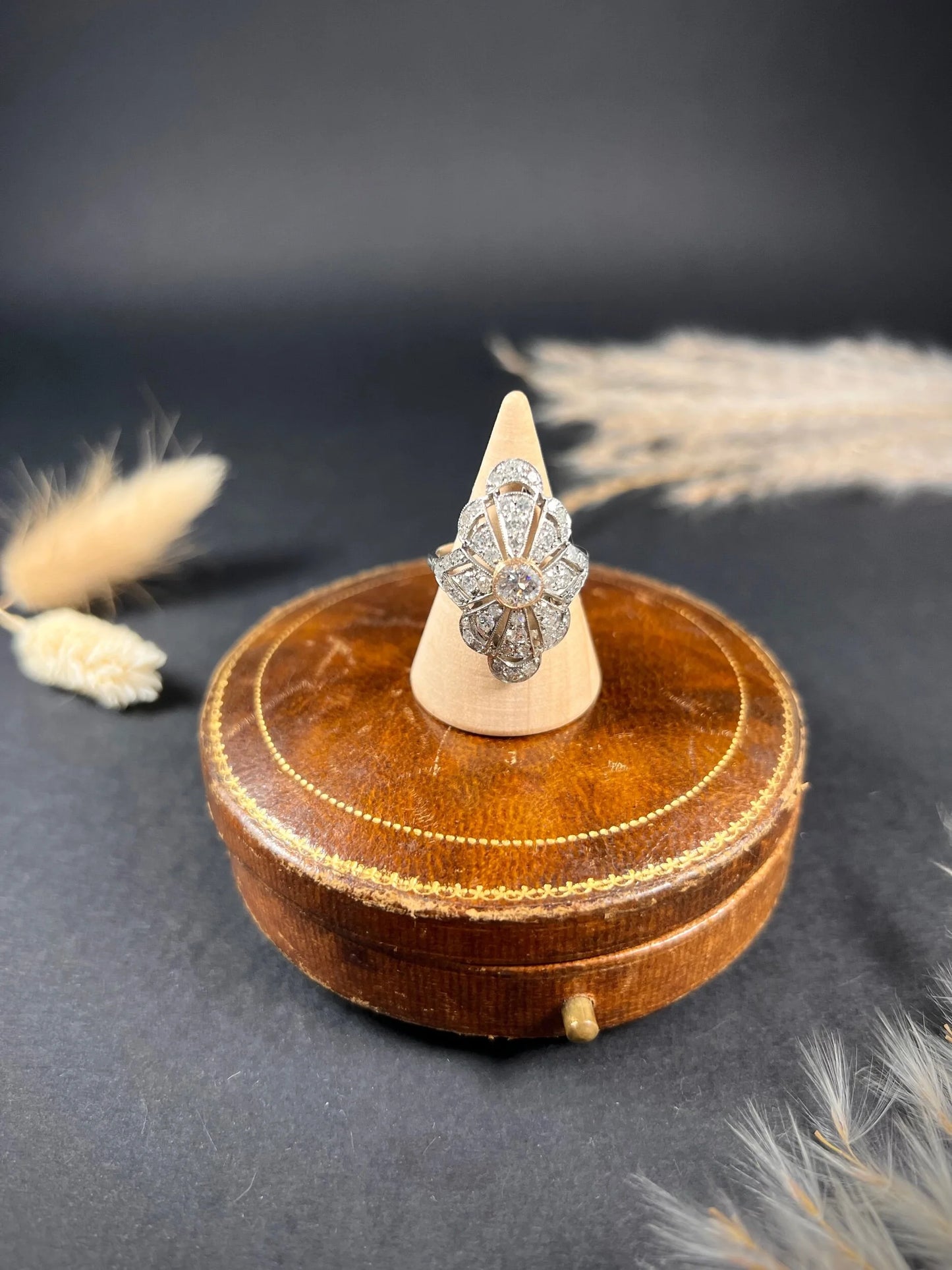 A diamond cocktail ring in white metal, on a ring cone