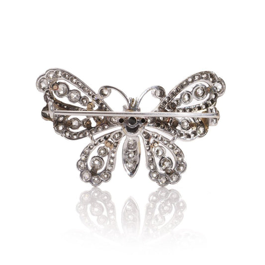 Antique white gold and silver butterfly brooch with diamonds and rubies.