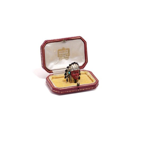 Cartier brooch in gold, silver and enamel set with gem.