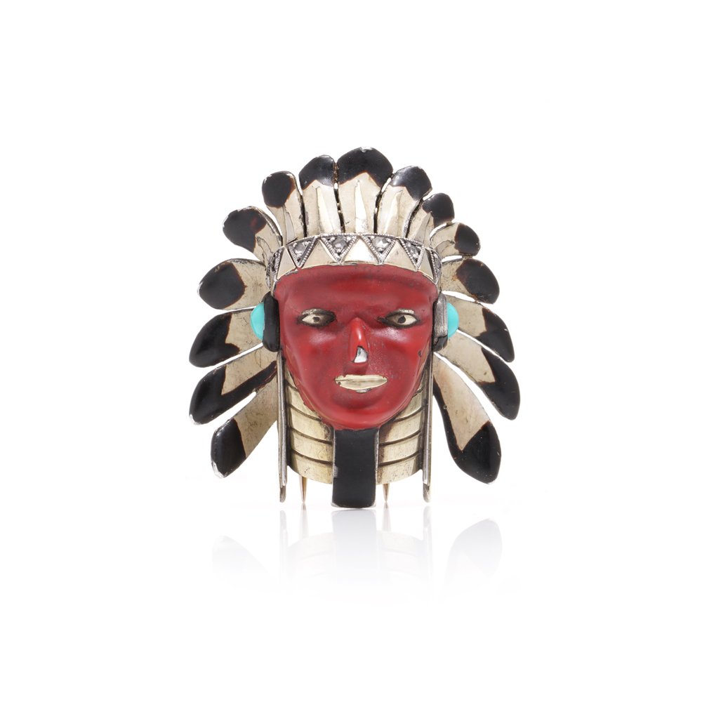 Cartier brooch in gold, silver and enamel set with gem.