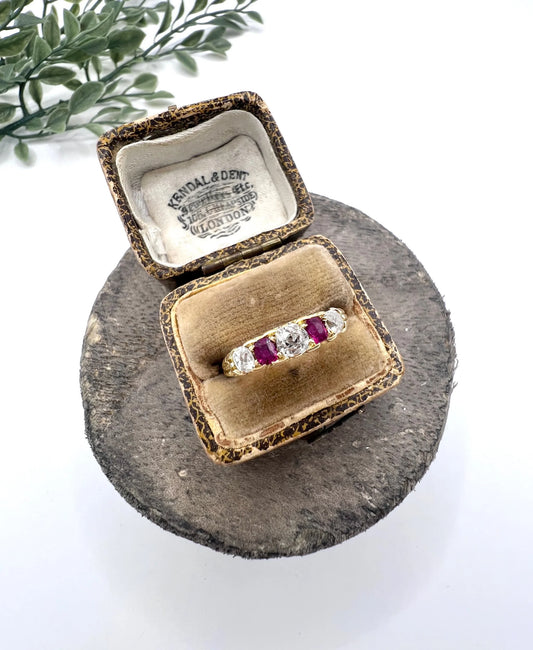 A yellow gold ruby and diamond five stone ring, in a ring box