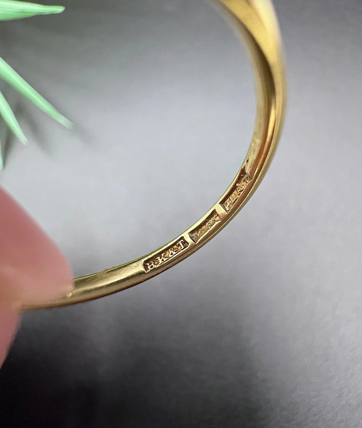 Stamps inside a yellow gold ring shank