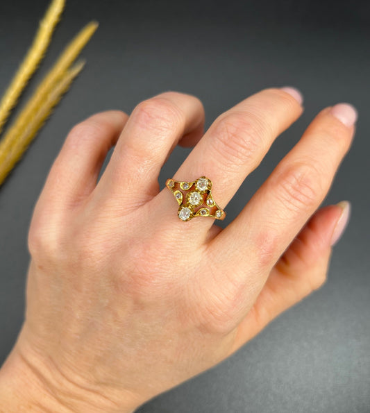 An antique old cut diamond ring in yellow gold, modelled on a hand