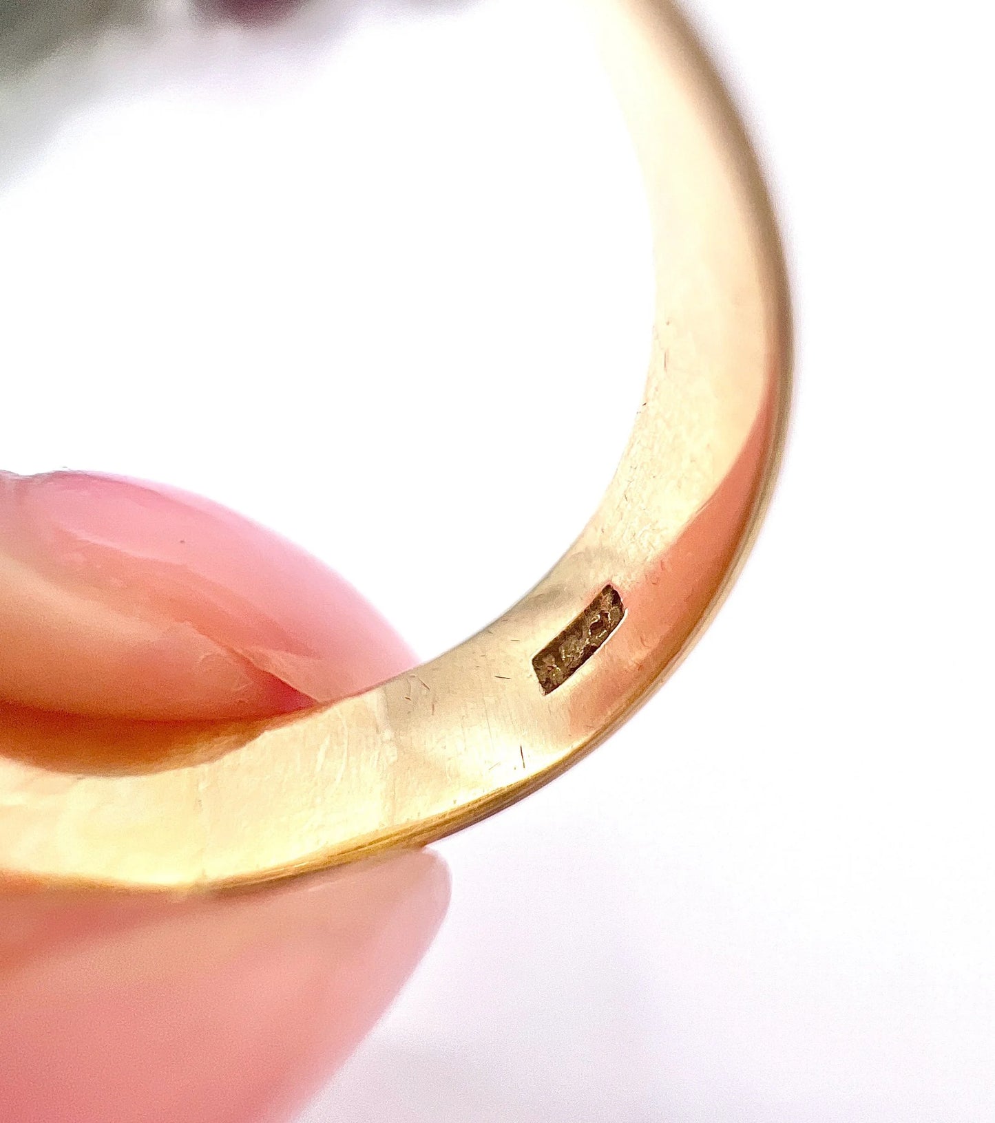 Close-up of an 18CT stamp inside a yellow gold ring shank
