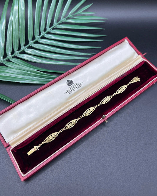 A yellow gold floral link bracelet, in a bracelet box