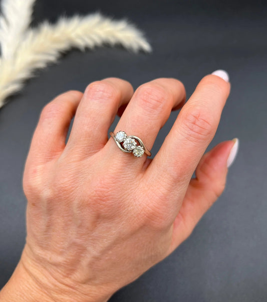 A three stone diamond crossover ring, modelled on a hand