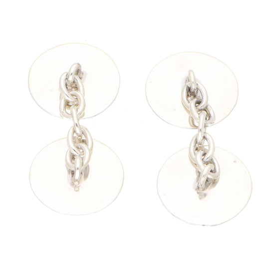 A pair of circular chain link cufflinks on a white background