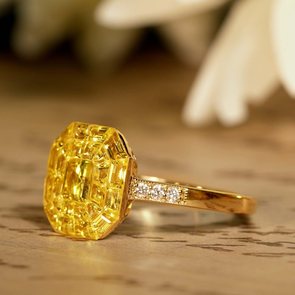 Yellow Sapphire Octagonal Cluster Solitaire Engagement Ring, 5.27cts yellow sapphires arranged in an invisible setting to produce an octagonal shaped design in 14ct yellow gold with diamond set shoulders