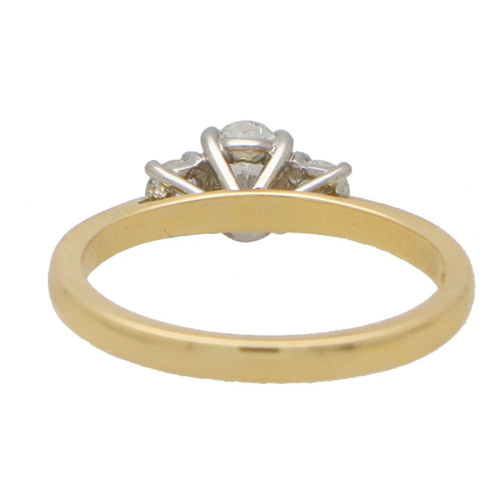 Diamond three stone ring in yellow gold and platinum.