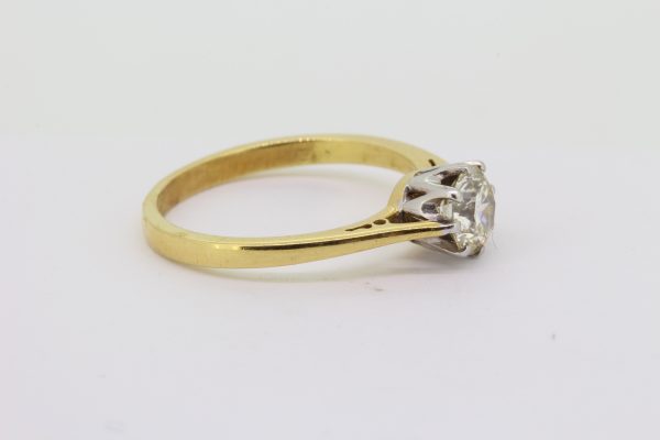Classic Diamond Solitaire Engagement Ring; 0.73 carat round brilliant-cut diamond set in 18ct white gold, mounted to a plain 18ct yellow gold shank