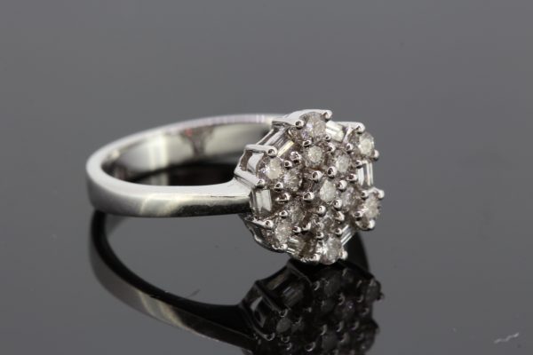 Contemporary Diamond Floral Cluster Ring; circular and baguette-cut diamonds arranged in a geometric floral design, in 18ct white gold
