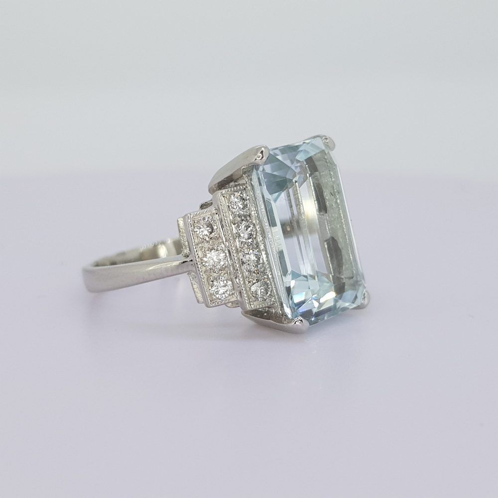Emerald Cut Aquamarine and Diamond Dress Ring; large 6.50 carat emerald-cut aquamarine, claw set, with 0.45cts diamond-set stepped shoulders, in platinum