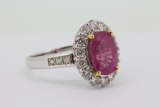 Pink Sapphire and Diamond Oval Cluster Ring; central 4.17 carat oval faceted pink sapphire with 0.92cts diamond surround and diamond-set shoulders, in 18ct white gold