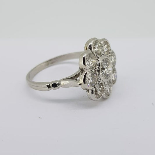 Diamond Daisy Flower Cluster Ring, 2.17 carat total, central 0.57ct diamond surrounded by eight diamonds totalling 1.60cts, in 18ct white gold