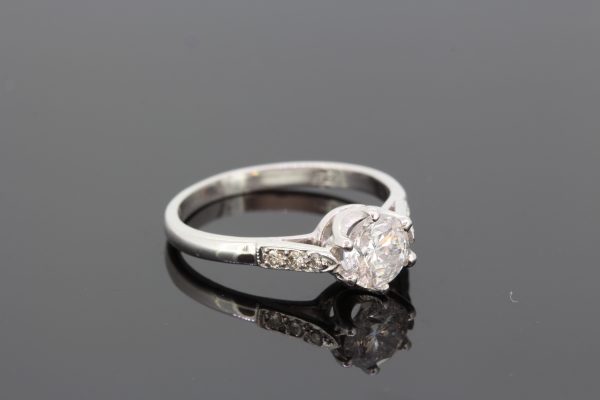 Diamond Solitaire Engagement Ring; central 0.96 carat diamond flanked by delicate diamond-set shoulders, Mounted in 18ct white gold