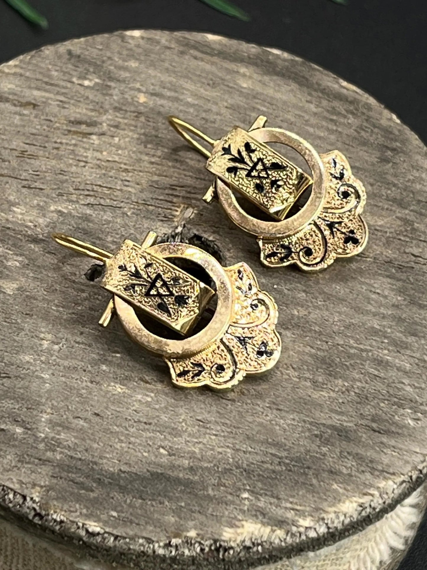 A pair of yellow gold and black enamel drop earrings