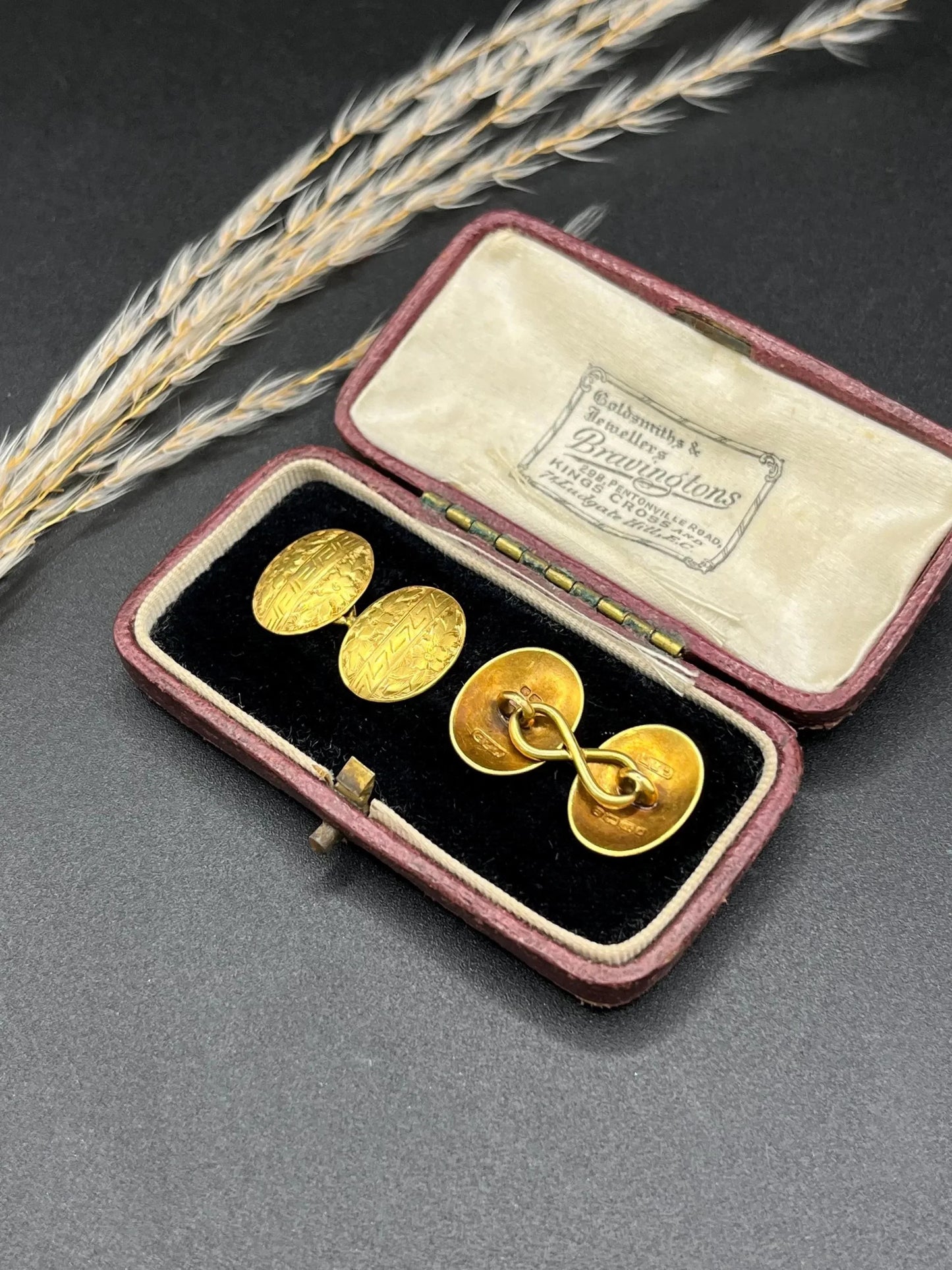 A pair of oval yellow gold floral engraved cufflinks, in an antique box