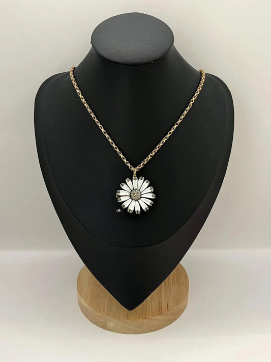 A white enamel and diamond flower pendant-brooch, modelled with a gold chain