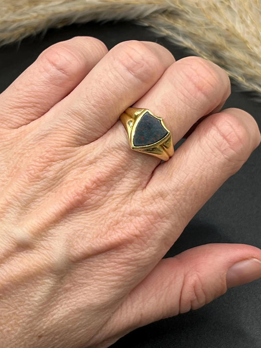 A yellow gold shield shaped bloodstone signet ring, modelled on a hand