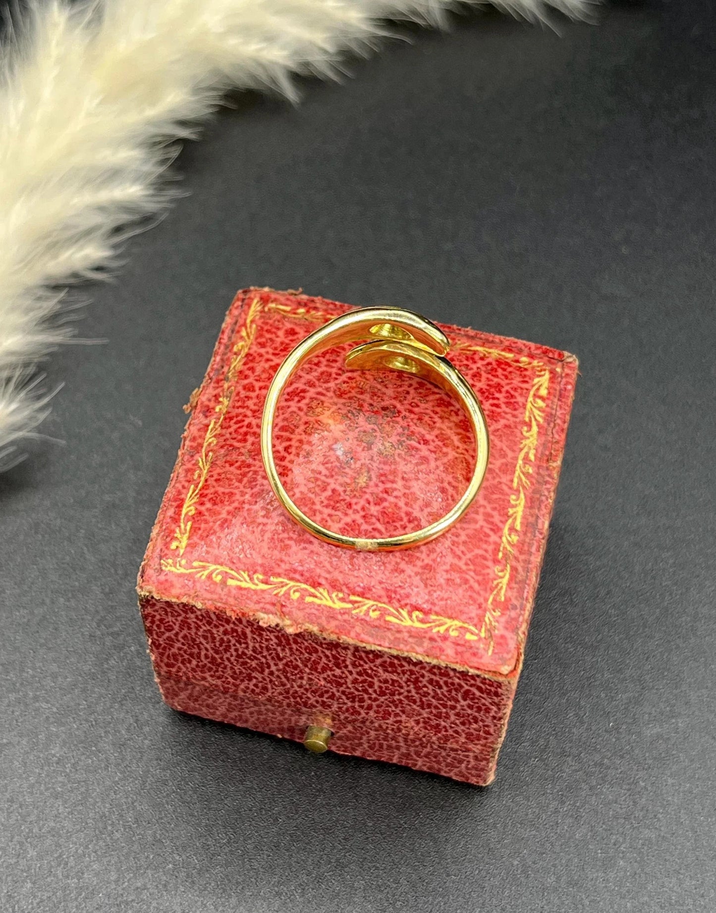 A yellow gold double headed snake ring with diamonds