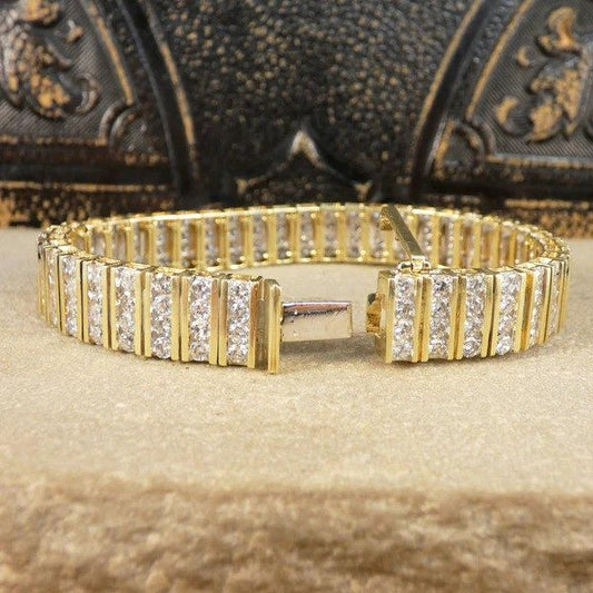Diamond panel link bracelet in 14 carat yellow gold.