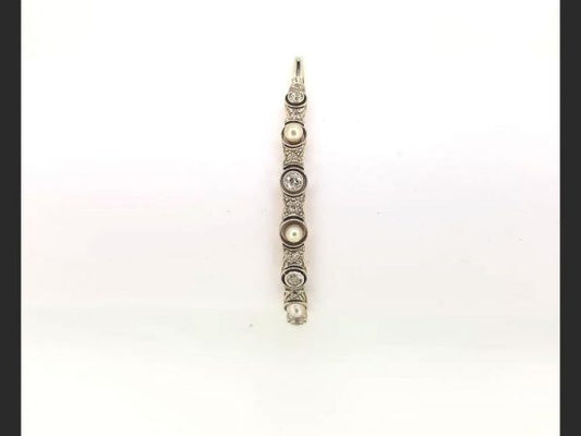 Vintage Pearl and Diamond Bangle; Pearls and round cut diamonds set into an 18ct white gold and platinum bangle.
