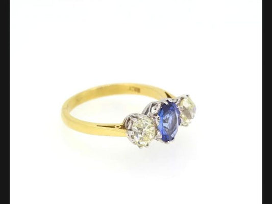 Classic sapphire and diamond trilogy ring; Central oval cut Sapphire flanked by two round cut diamonds