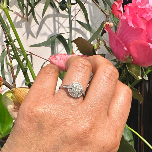 A halo target cluster ring set with diamonds in platinum, modelled on a hand